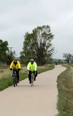 Two bike riders on the Poudre River Trail, Colorado